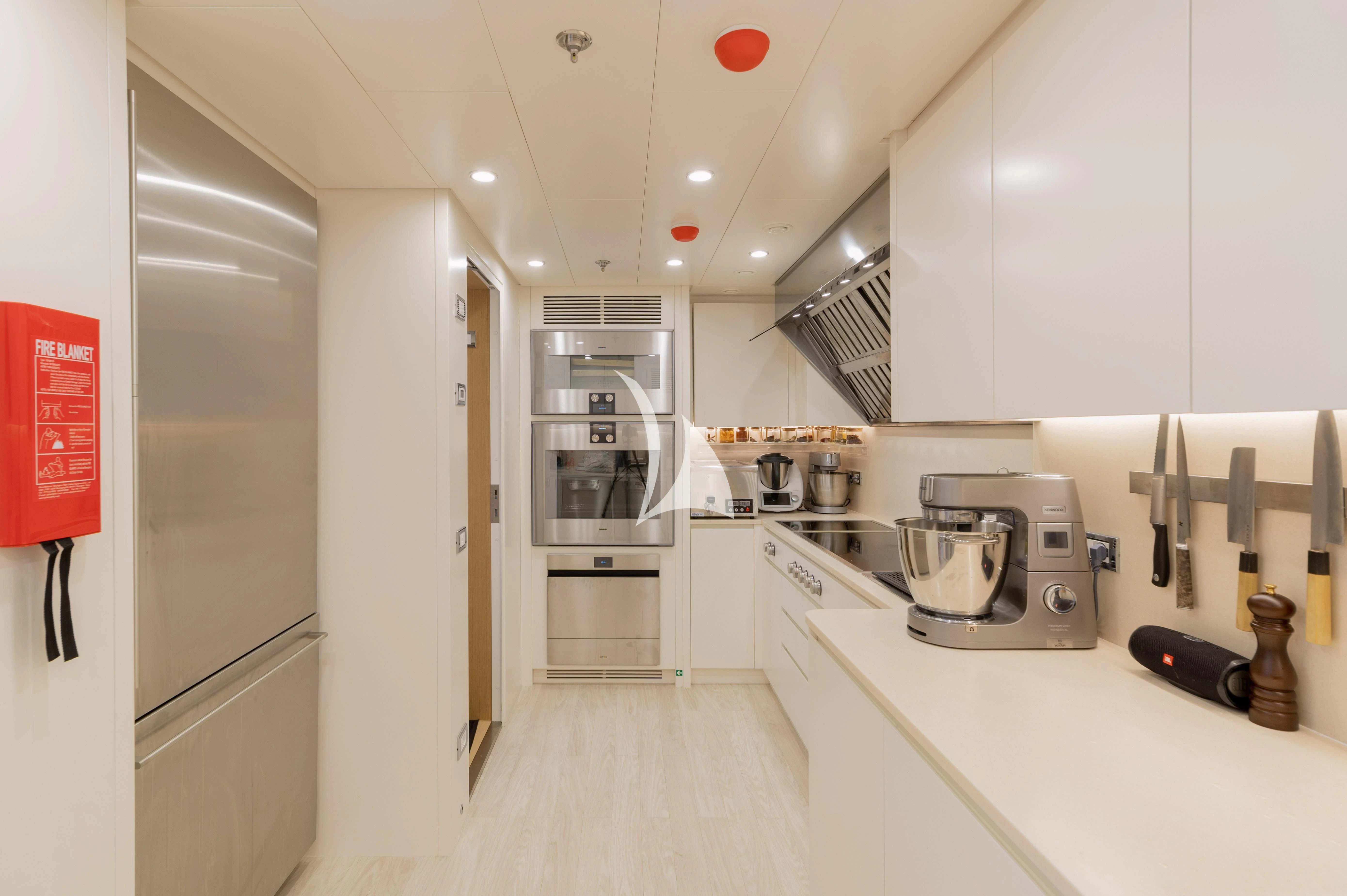 a kitchen with white cabinets aboard BOJI Yacht for Sale