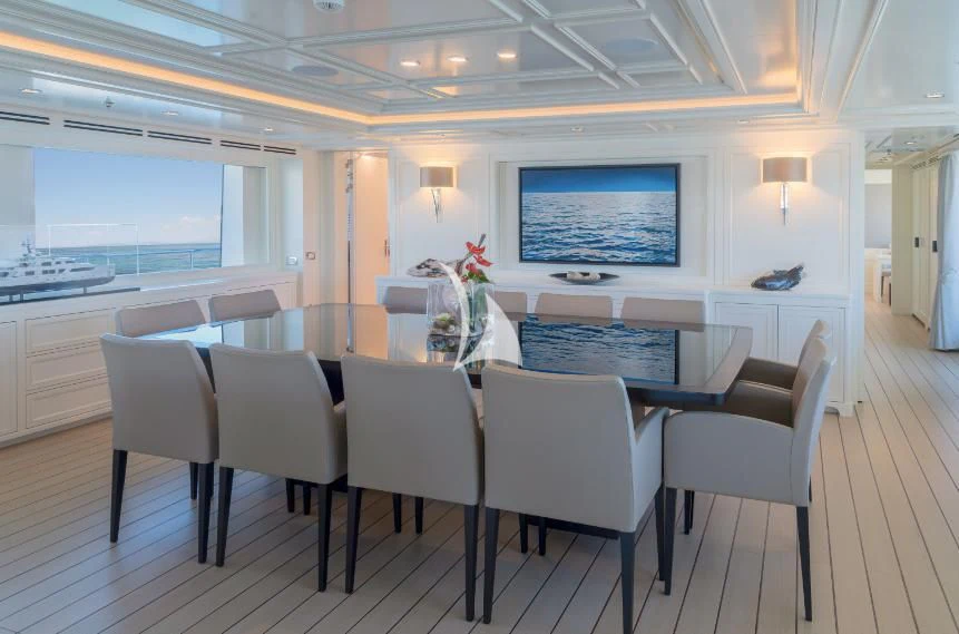 a large room with a table and chairs aboard BOJI Yacht for Sale