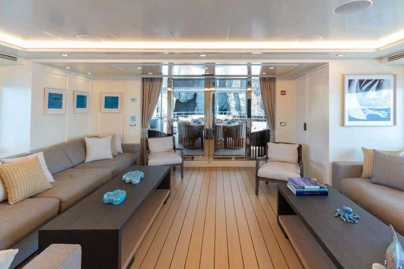 a living room with a wood floor aboard BOJI Yacht for Sale