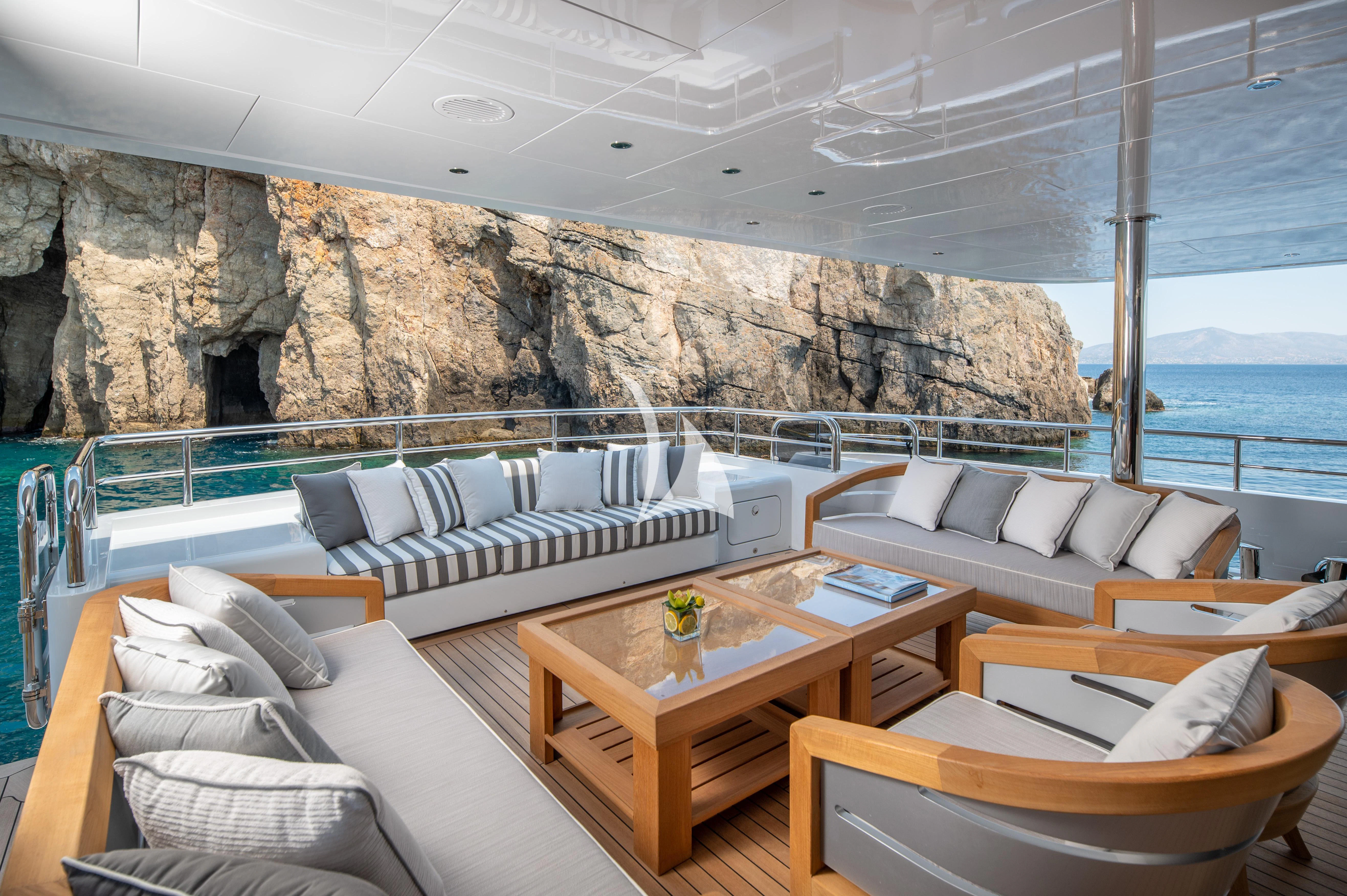 a living room with a large stone wall aboard BOJI Yacht for Sale