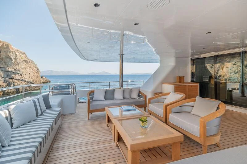 a room with a table chairs and a large body of water aboard BOJI Yacht for Sale