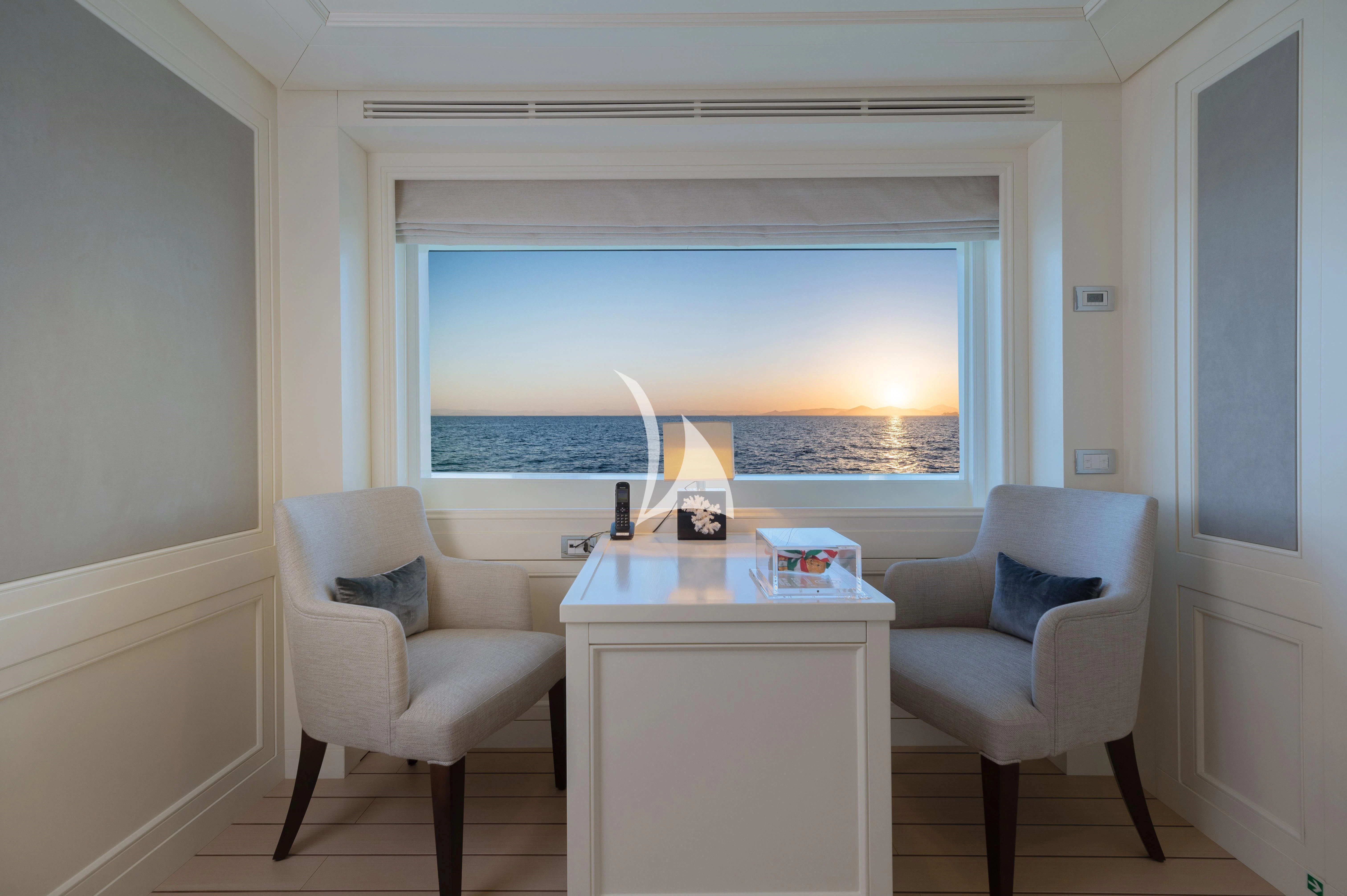 a room with a table and chairs aboard BOJI Yacht for Sale