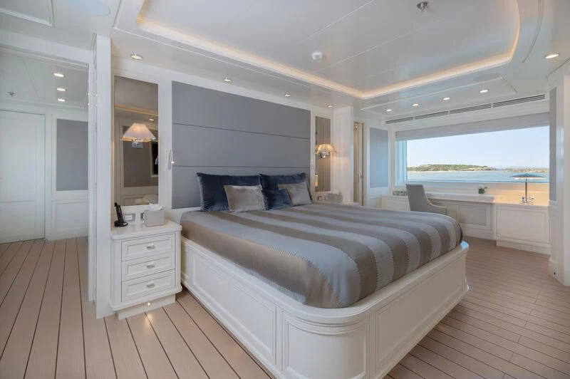 a large bedroom with a large bed aboard BOJI Yacht for Sale