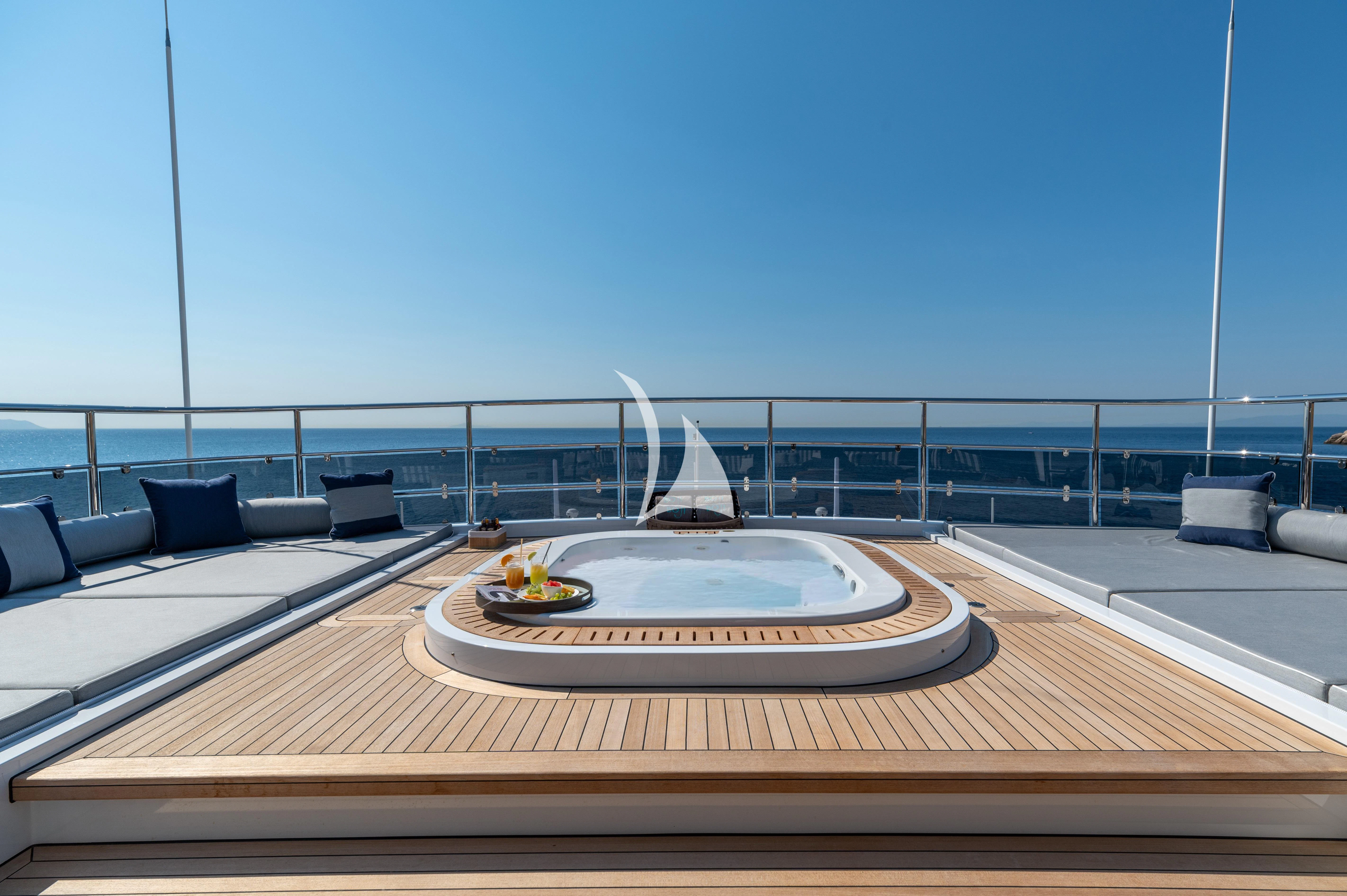 a pool table with a view of the ocean and a sailboat in the distance aboard BOJI Yacht for Sale