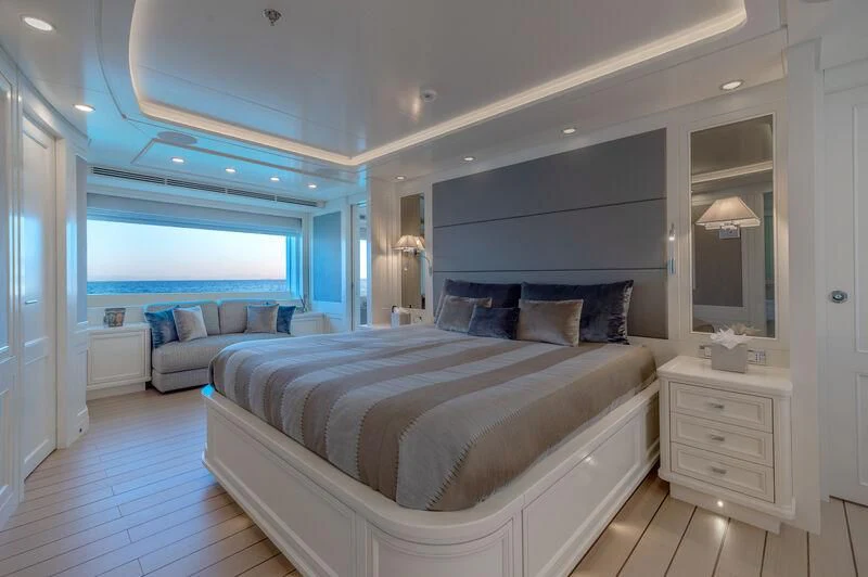 a large bedroom with a large bed aboard BOJI Yacht for Sale
