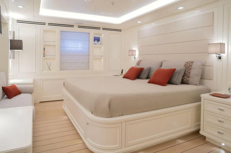 a large white bed in a room aboard BOJI Yacht for Sale