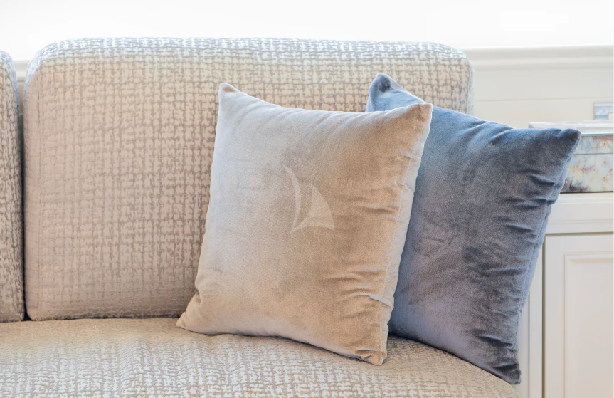 a brown pillow on a couch aboard BOJI Yacht for Sale
