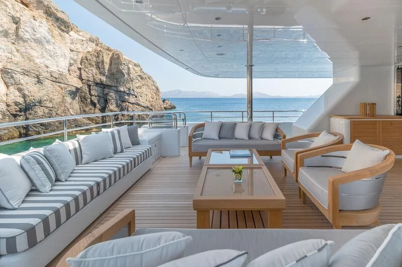 a room with a table chairs and a large body of water aboard BOJI Yacht for Sale