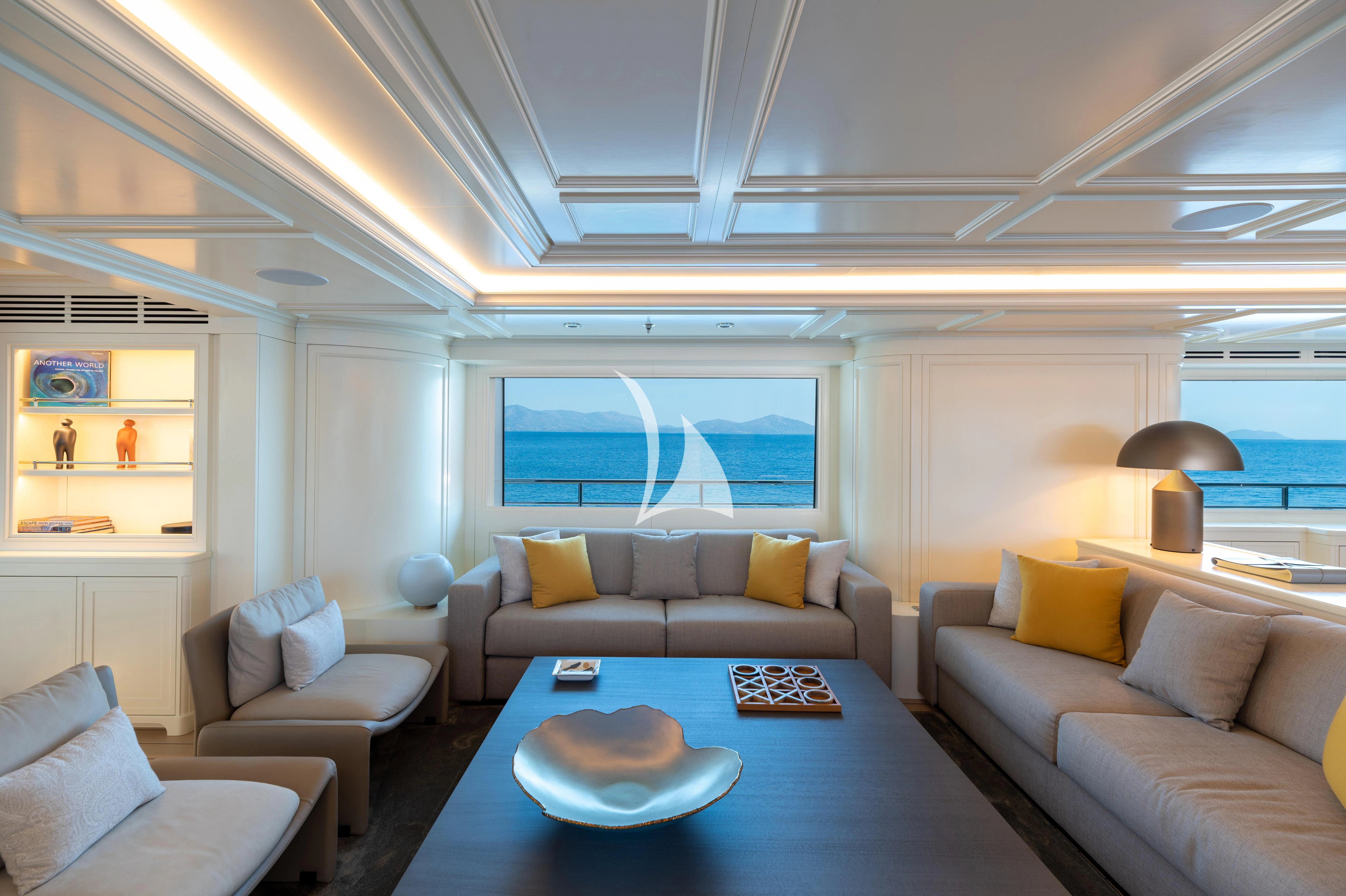 a living room with a table and couches aboard BOJI Yacht for Sale