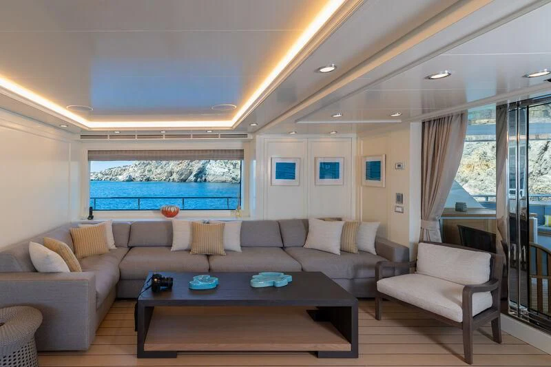 a living room with a large window aboard BOJI Yacht for Sale