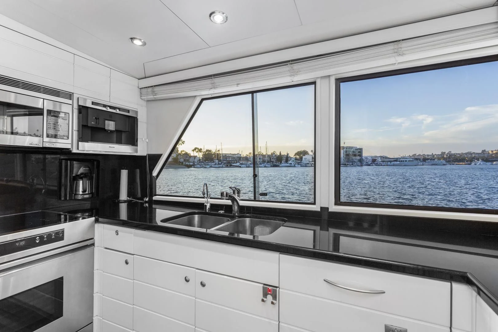 a kitchen with a large window aboard EL ENCANTO Yacht for Sale