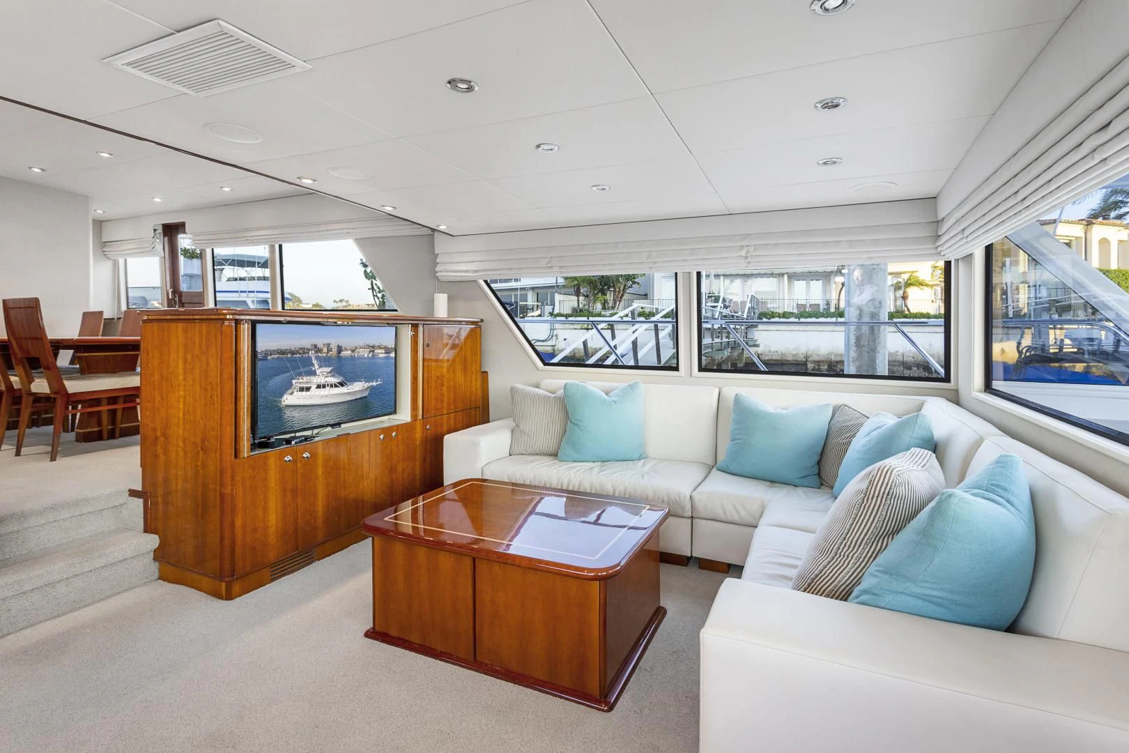a living room with a large screen aboard EL ENCANTO Yacht for Sale