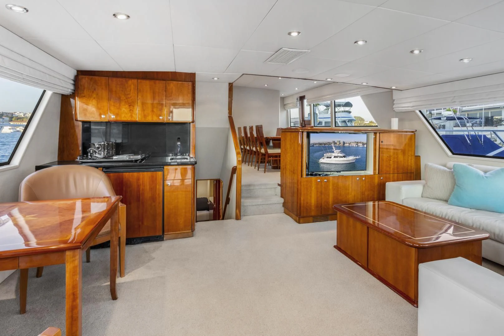 a living room with a table and chairs aboard EL ENCANTO Yacht for Sale