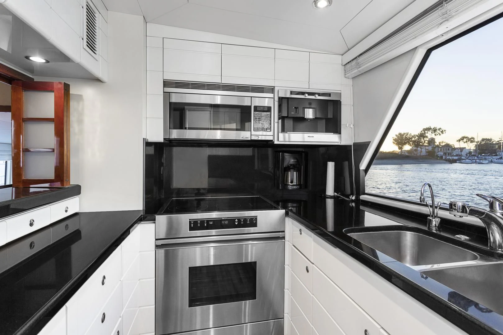 a kitchen with a sink and stove aboard EL ENCANTO Yacht for Sale