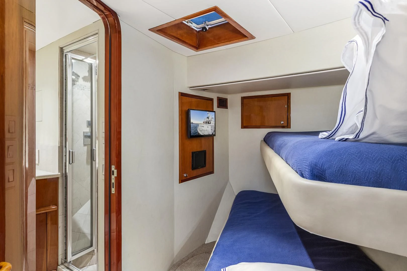 a room with a bed and a door aboard EL ENCANTO Yacht for Sale