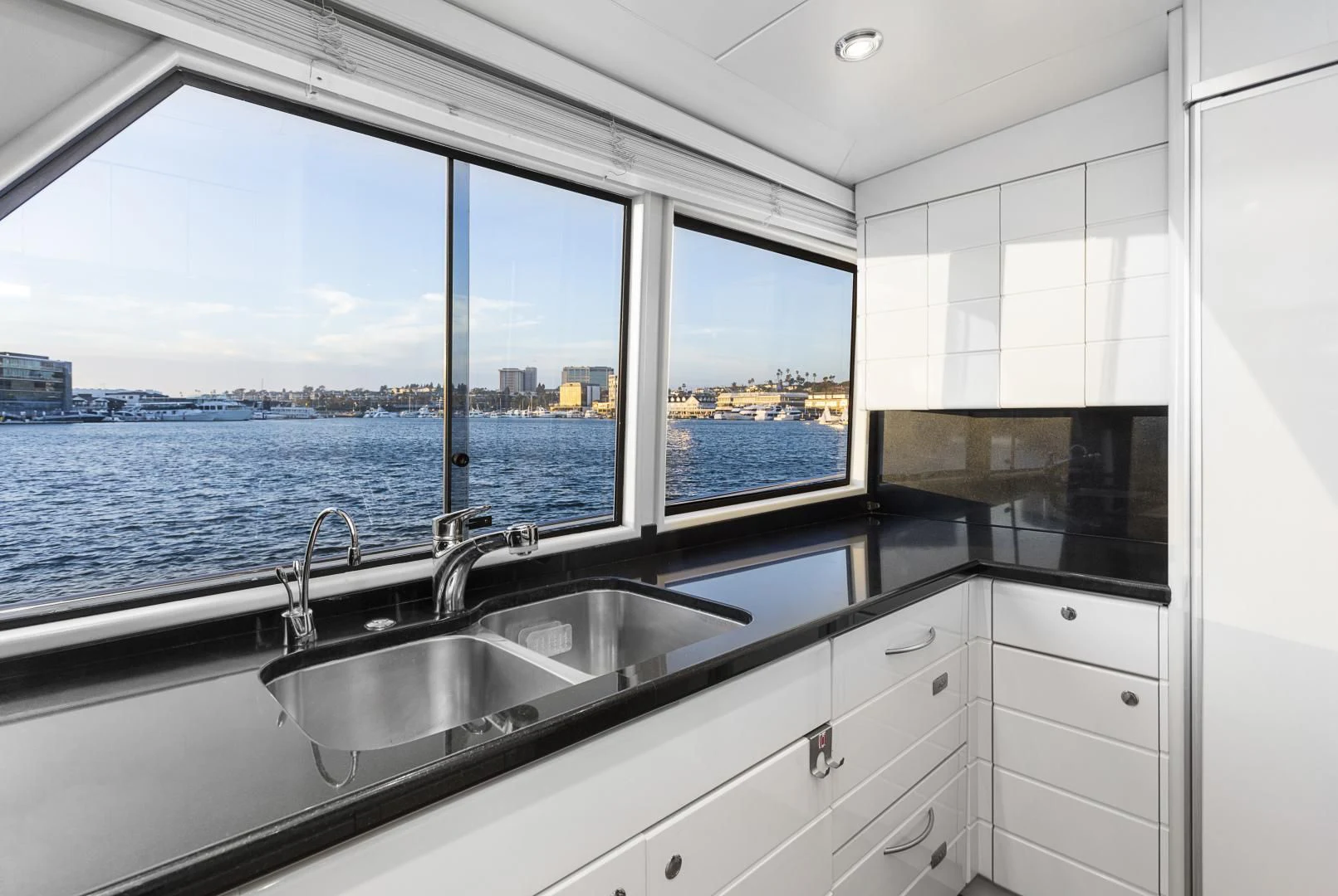 a kitchen with a sink and a window aboard EL ENCANTO Yacht for Sale