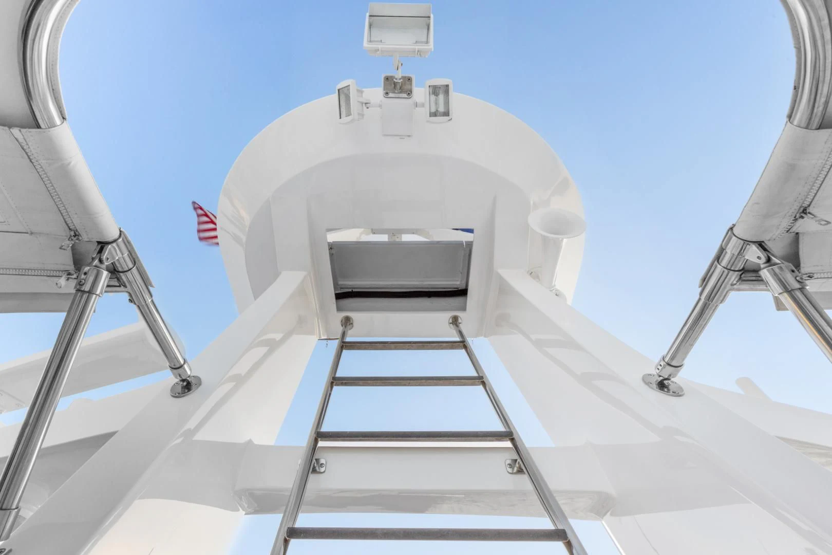 a white sink with a red and blue flag on it aboard EL ENCANTO Yacht for Sale