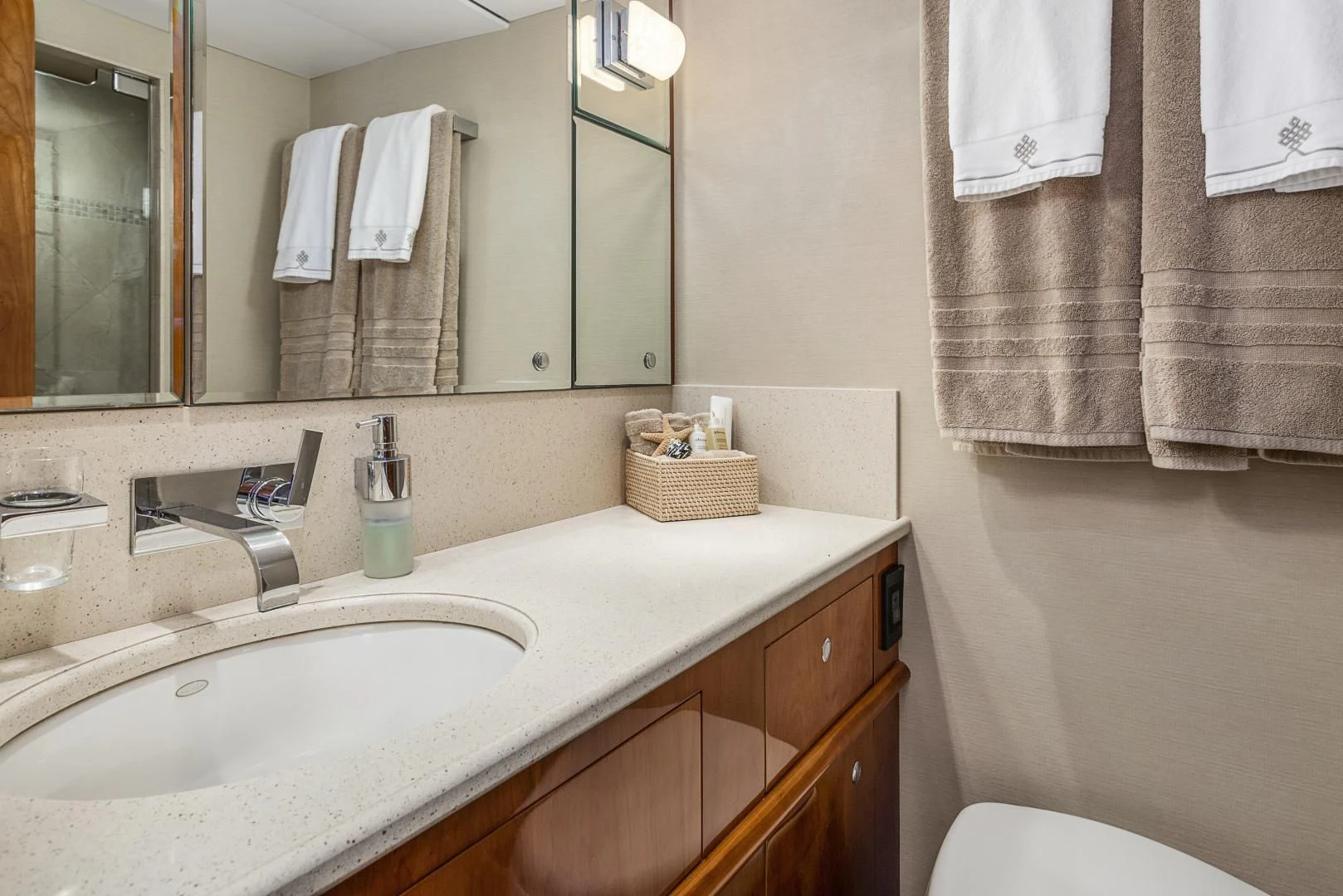 a bathroom with a sink and towels aboard EL ENCANTO Yacht for Sale