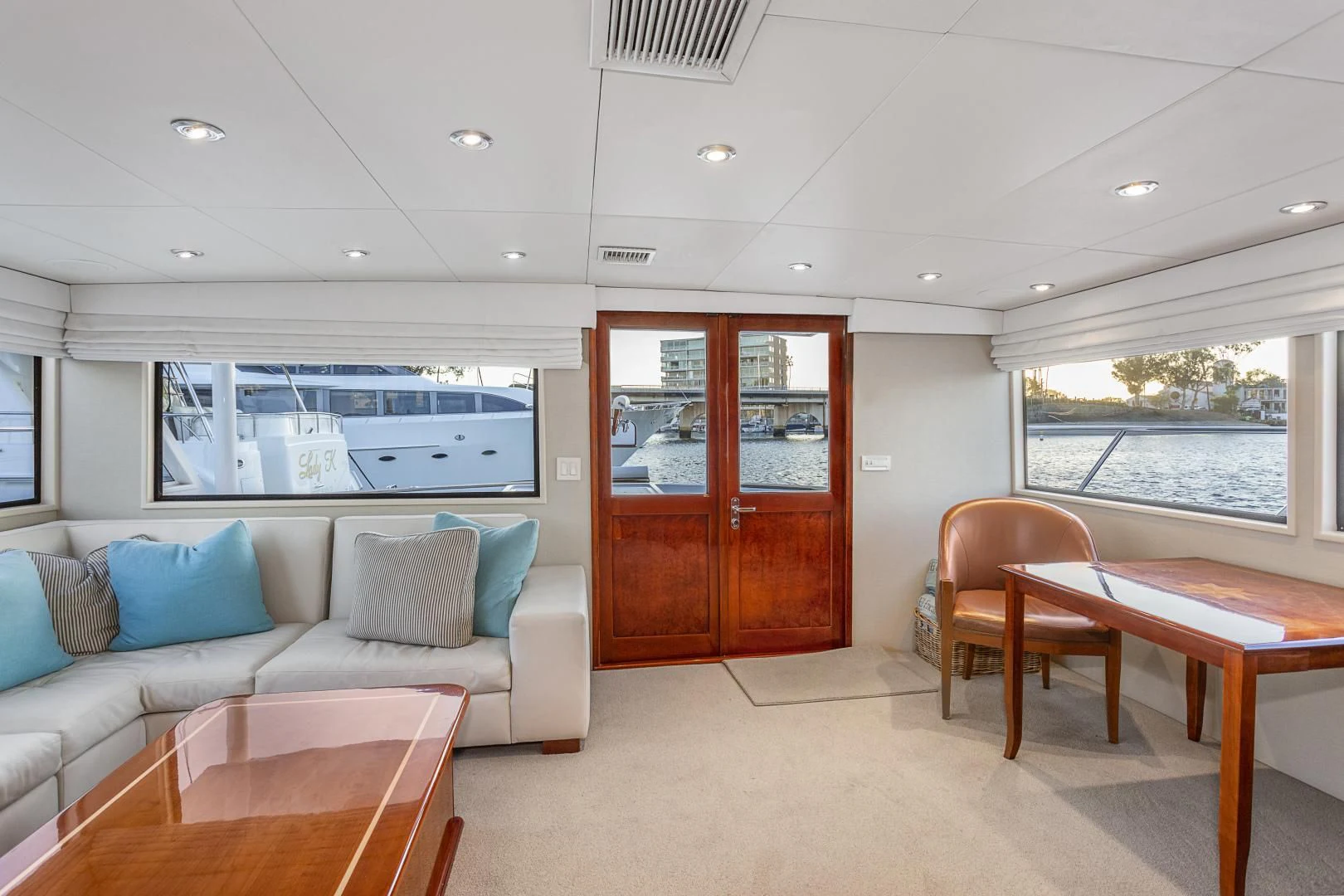 a living room with a couch and a table aboard EL ENCANTO Yacht for Sale