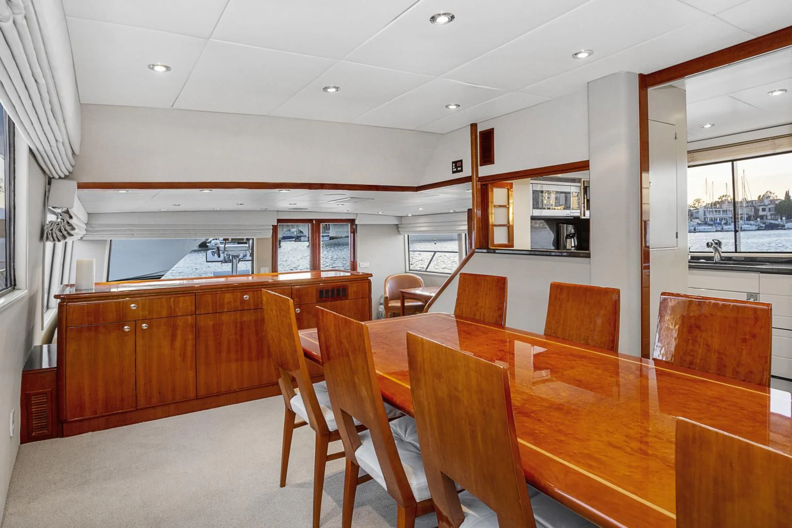 a room with tables and chairs aboard EL ENCANTO Yacht for Sale