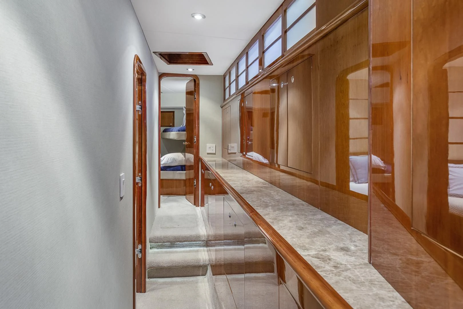 a long hallway with wooden doors aboard EL ENCANTO Yacht for Sale