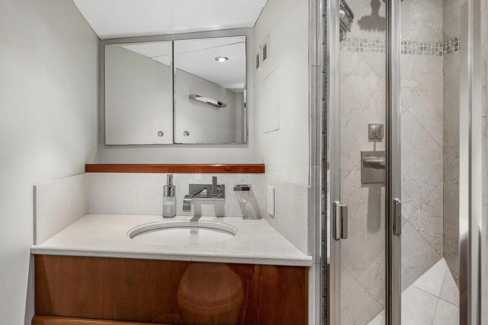 a bathroom with a sink and mirror aboard EL ENCANTO Yacht for Sale