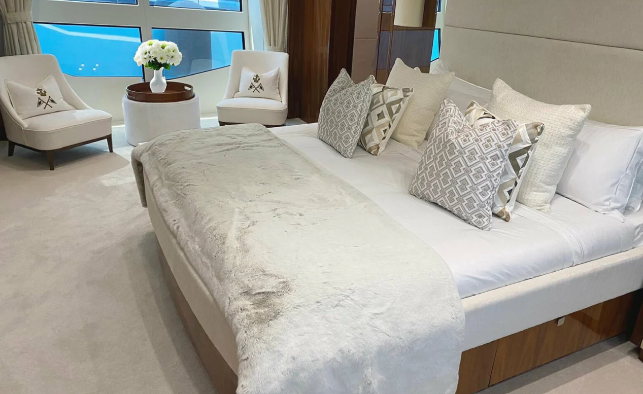 a bed with white pillows aboard ANYA Yacht for Sale