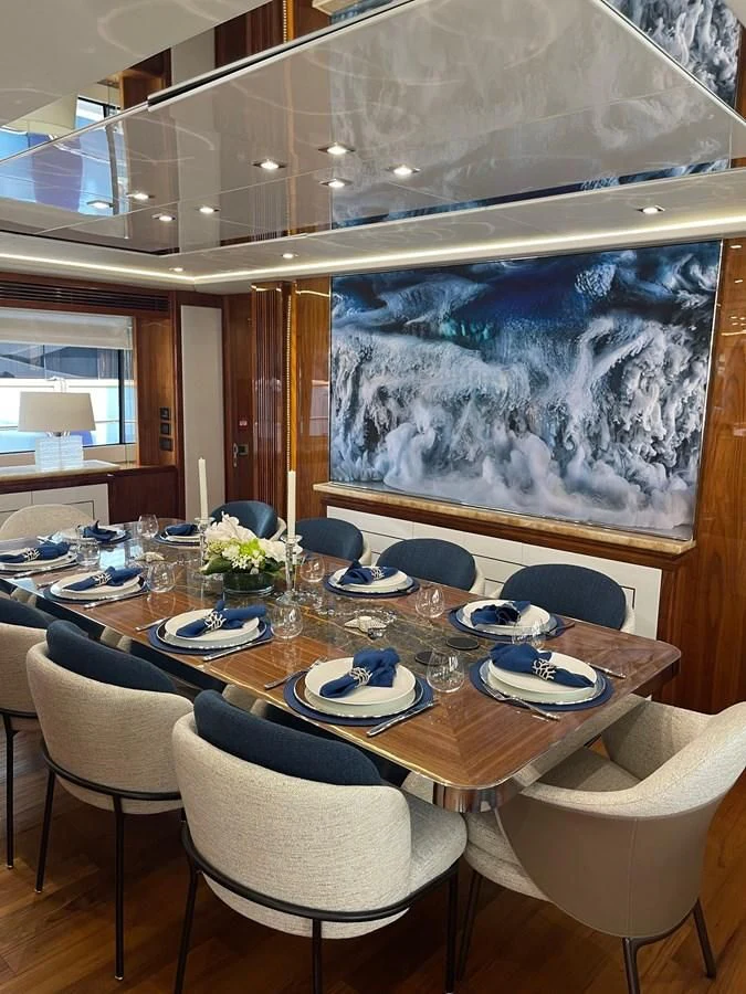 a dining room with a large painting aboard ANYA Yacht for Sale