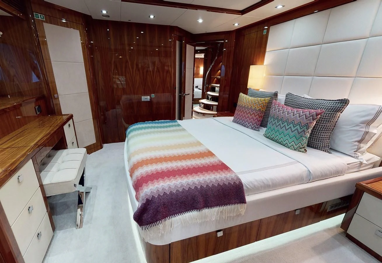 a room with a bed and a chair aboard ANYA Yacht for Sale