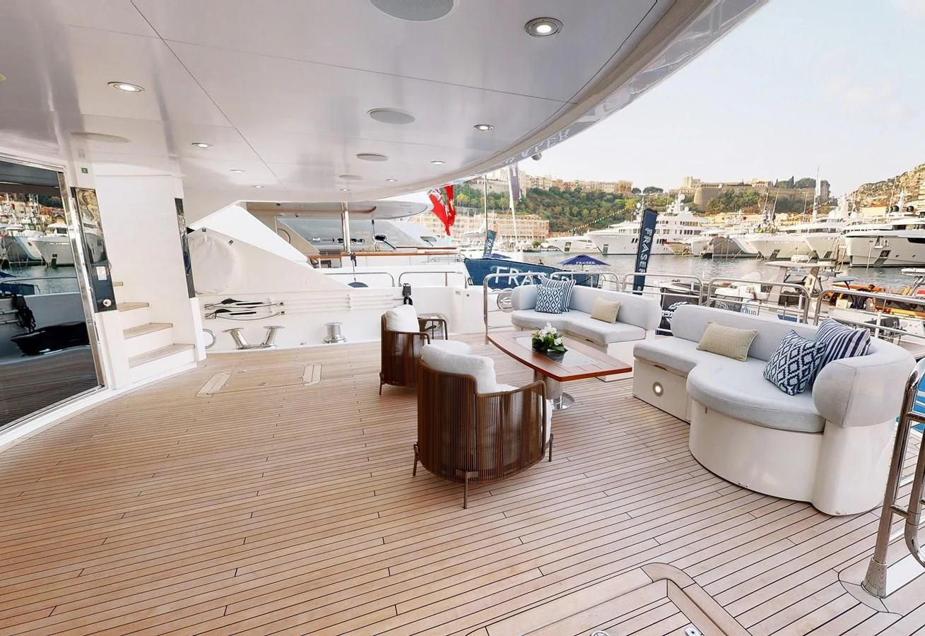 a large living room with a large deck and a view of the water aboard ANYA Yacht for Sale