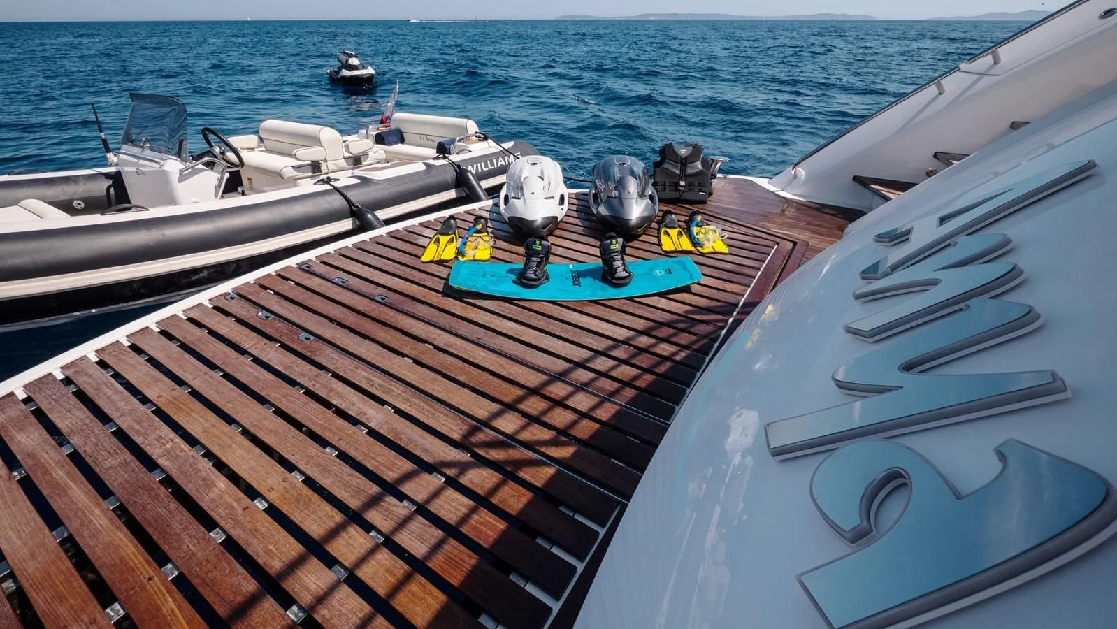 a deck with a boat and a dock with a couple of boats on it aboard ANYA Yacht for Sale