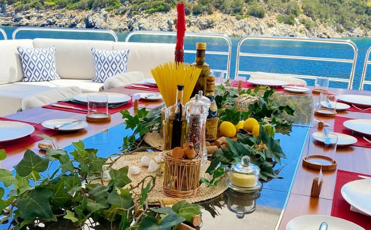 a table with food and drinks on it aboard ANYA Yacht for Sale