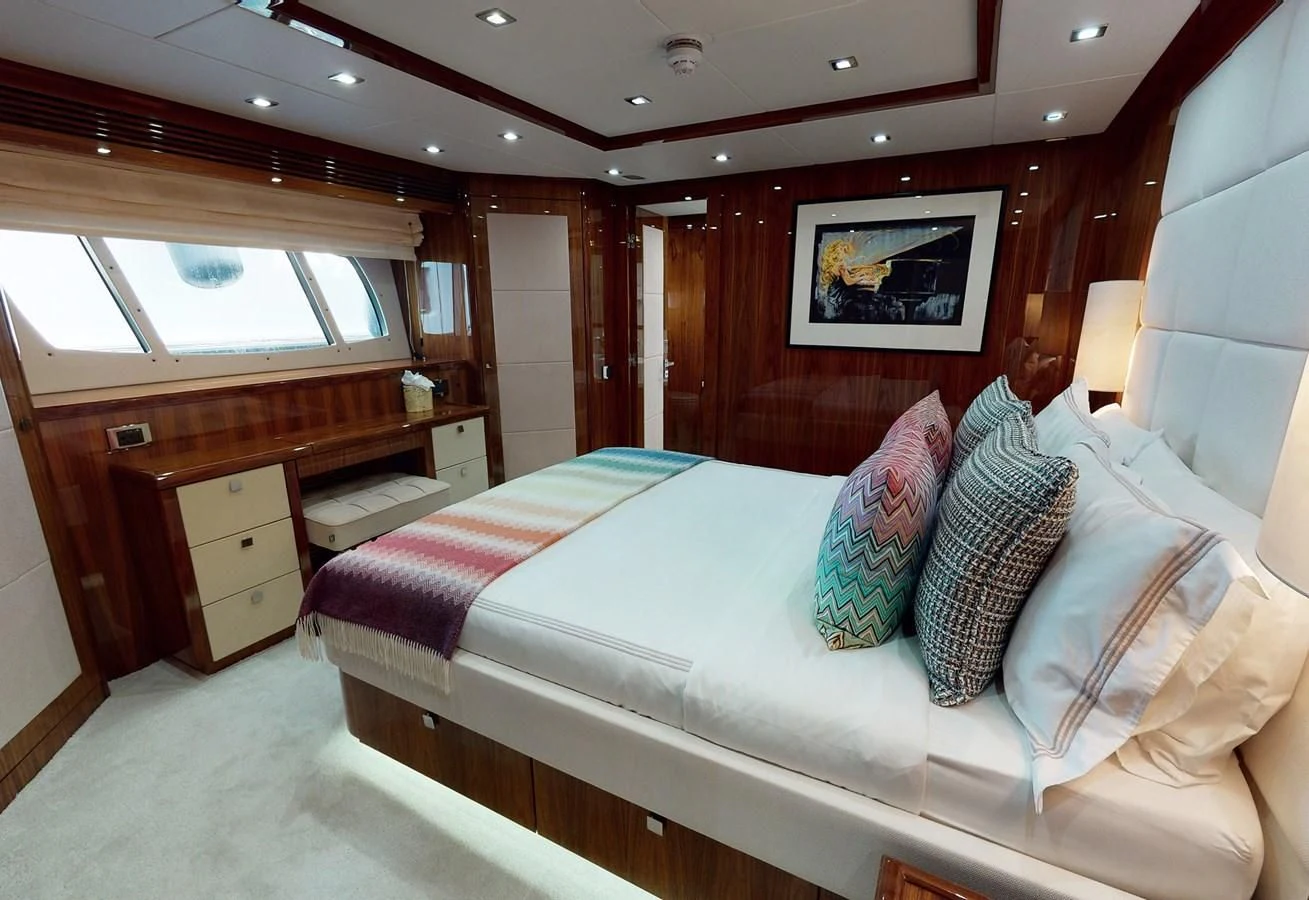 a bedroom with a bed and a desk aboard ANYA Yacht for Sale