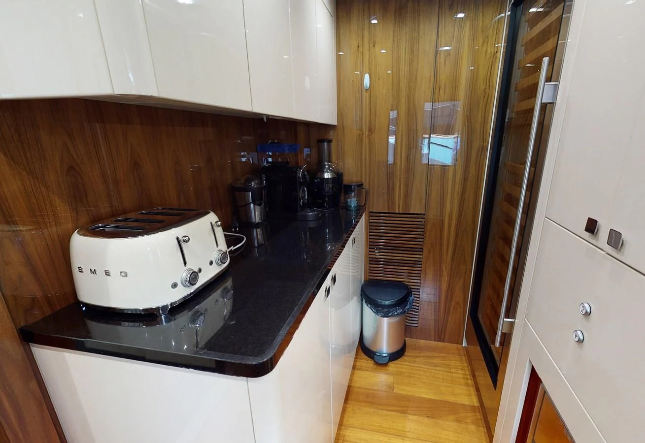 a white coffee maker on a kitchen counter aboard ANYA Yacht for Sale