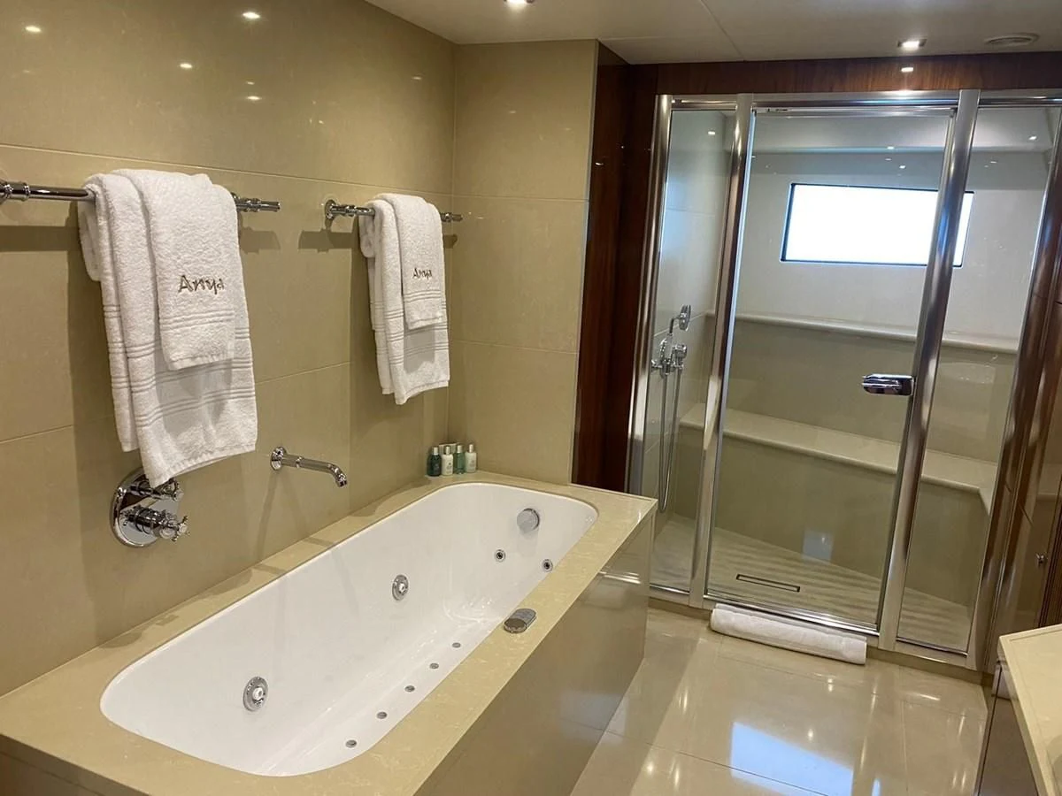 a bathroom with a bathtub and a sink aboard ANYA Yacht for Sale