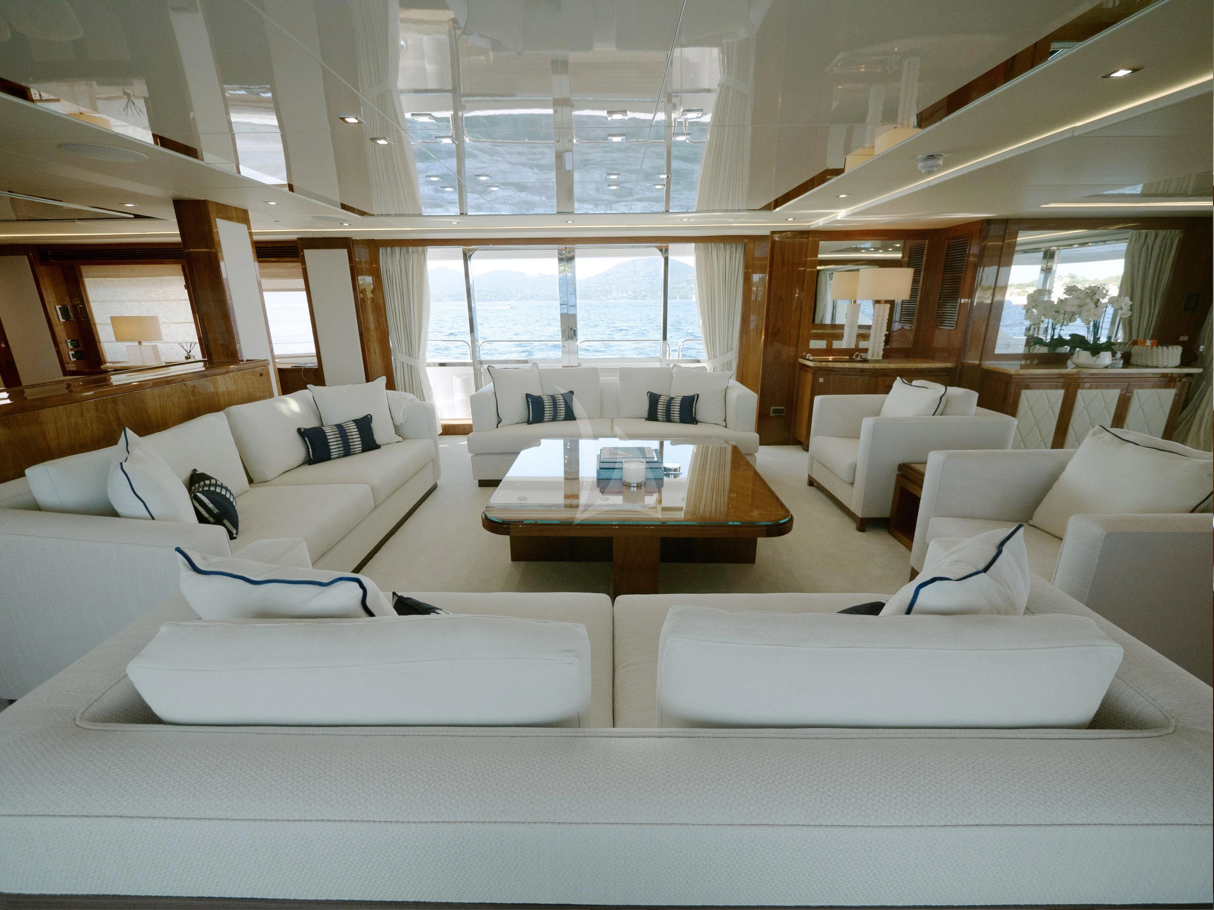 a room with white couches and a table aboard ANYA Yacht for Sale