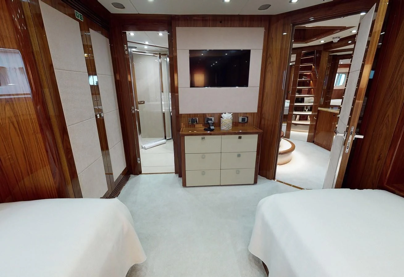 a room with a bed and a television aboard ANYA Yacht for Sale