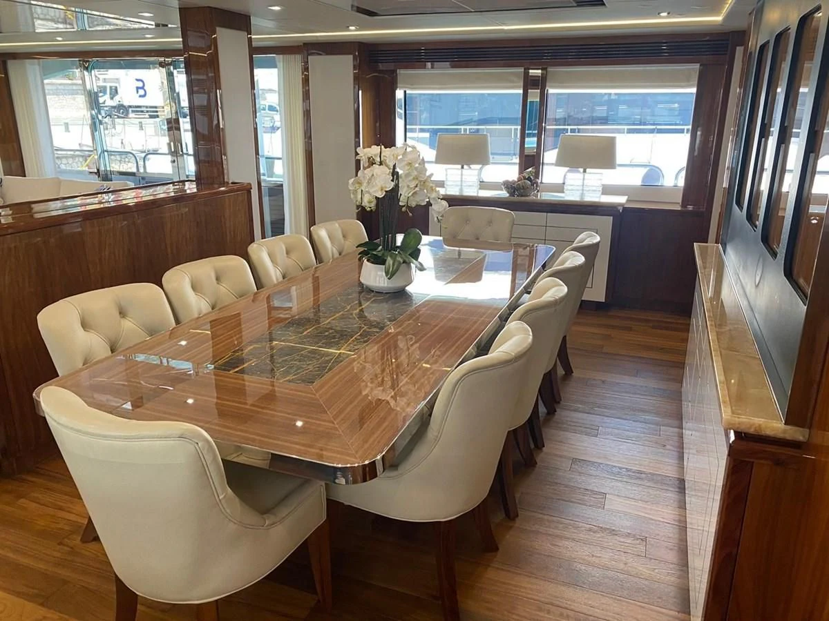 a dining room with a table and chairs aboard ANYA Yacht for Sale