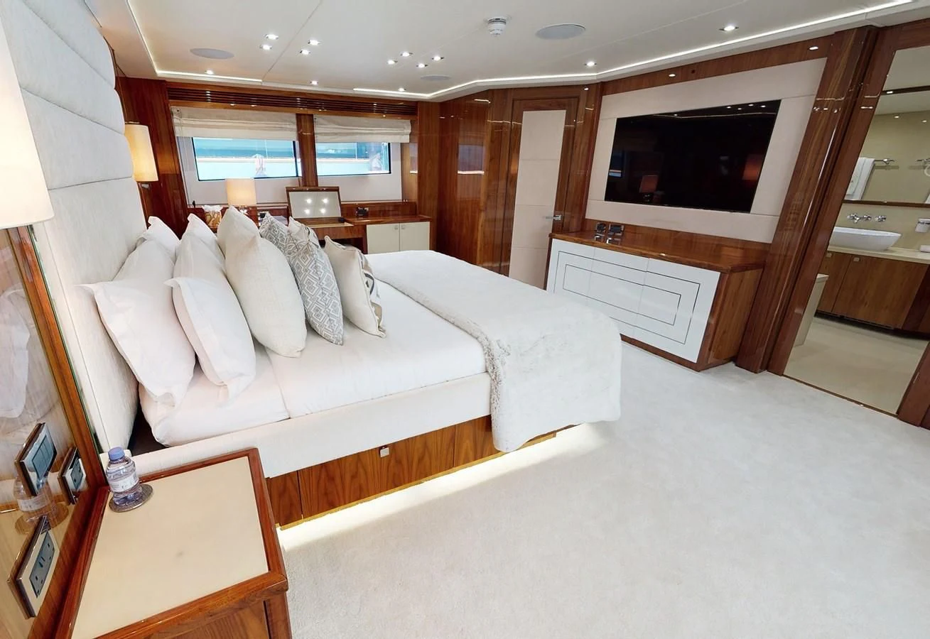 a room with a bed and a television aboard ANYA Yacht for Sale