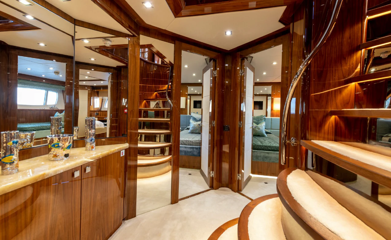 a room with a large mirror and a counter with a sink and a bed aboard ANYA Yacht for Sale