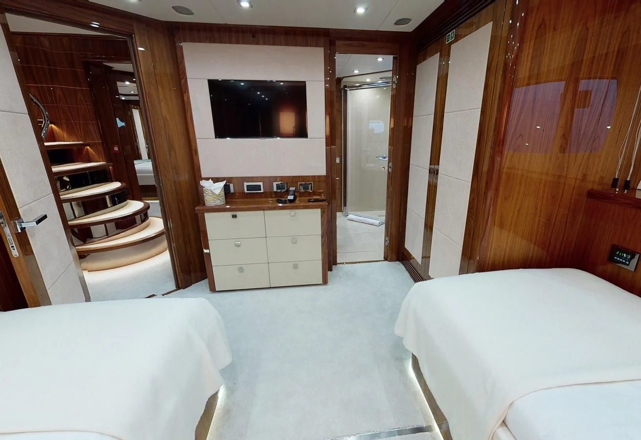 a room with a bed and a television aboard ANYA Yacht for Sale