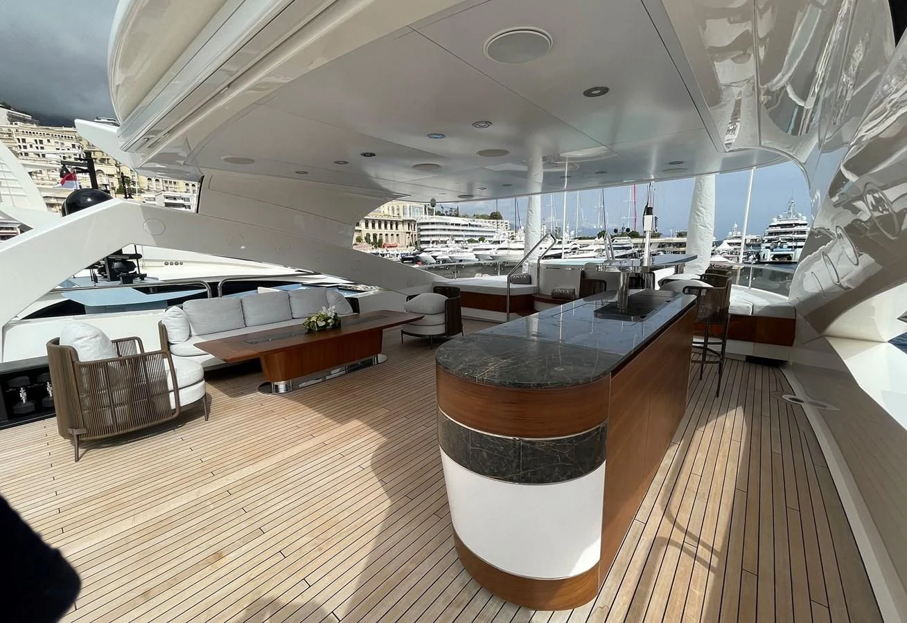 a room with a wood floor and a large window with a view of the city below aboard ANYA Yacht for Sale