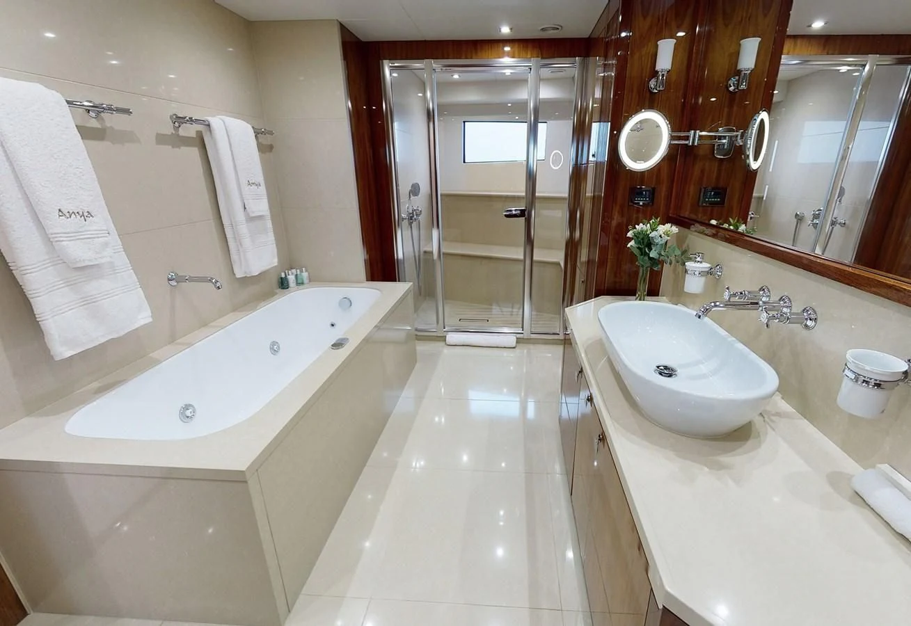 a bathroom with a tub sink and a sink aboard ANYA Yacht for Sale