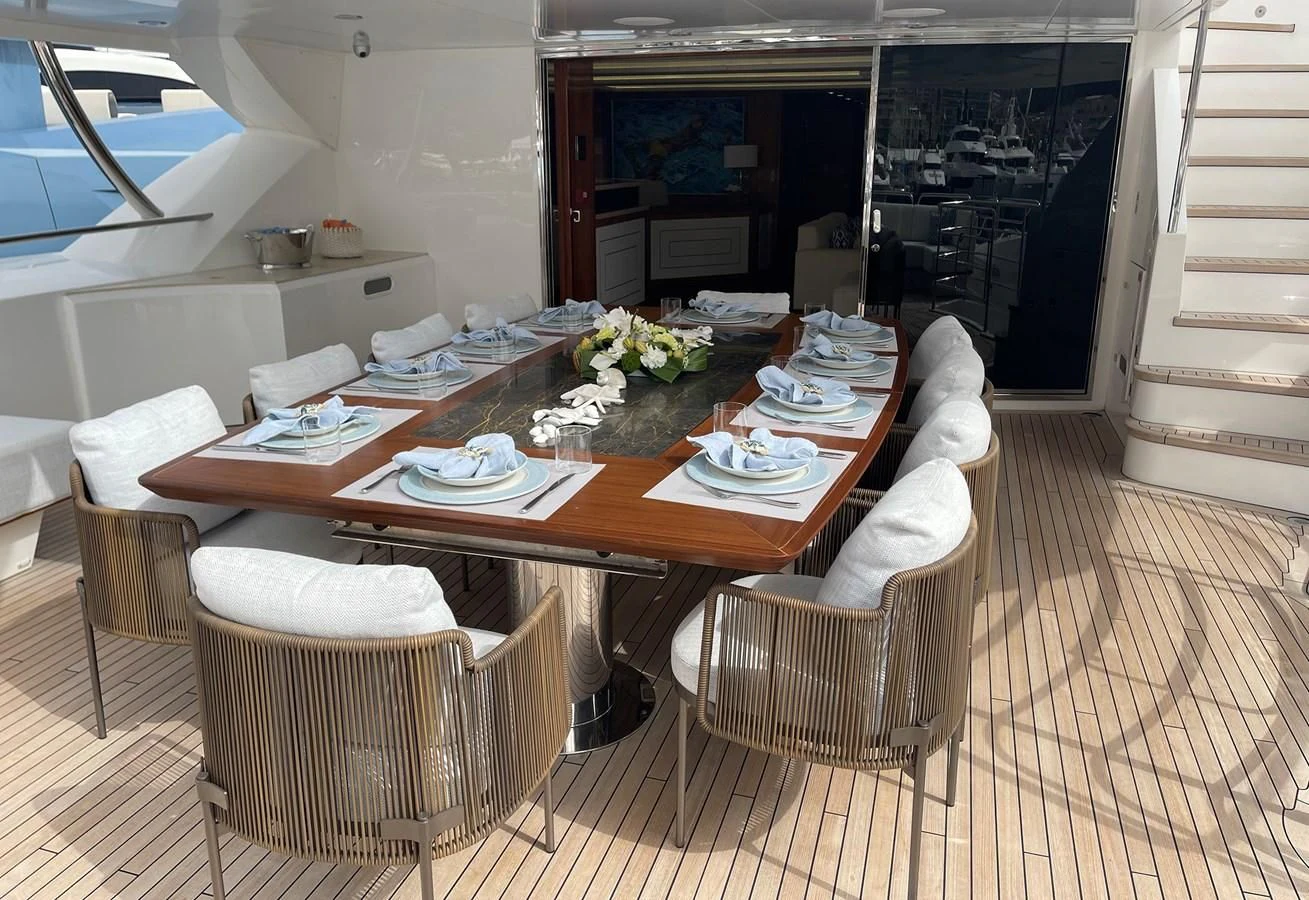 a table with plates and chairs aboard ANYA Yacht for Sale