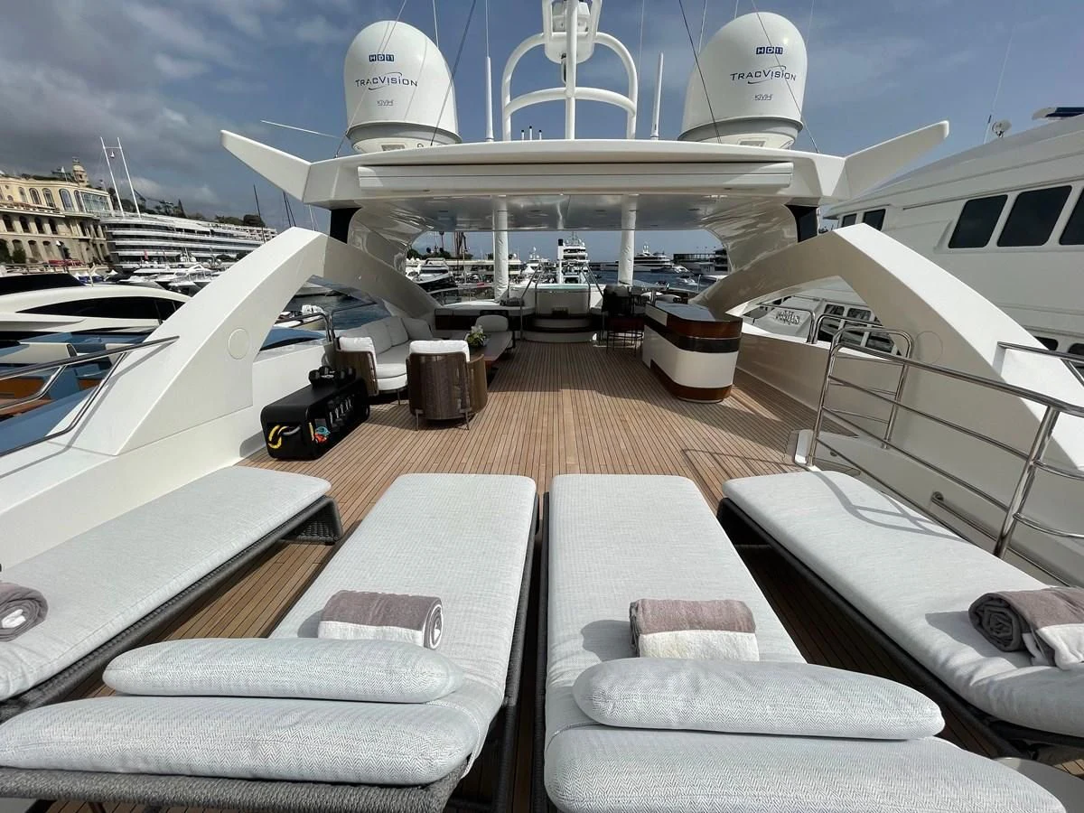 a deck with a deck chairs and a boat on it aboard ANYA Yacht for Sale