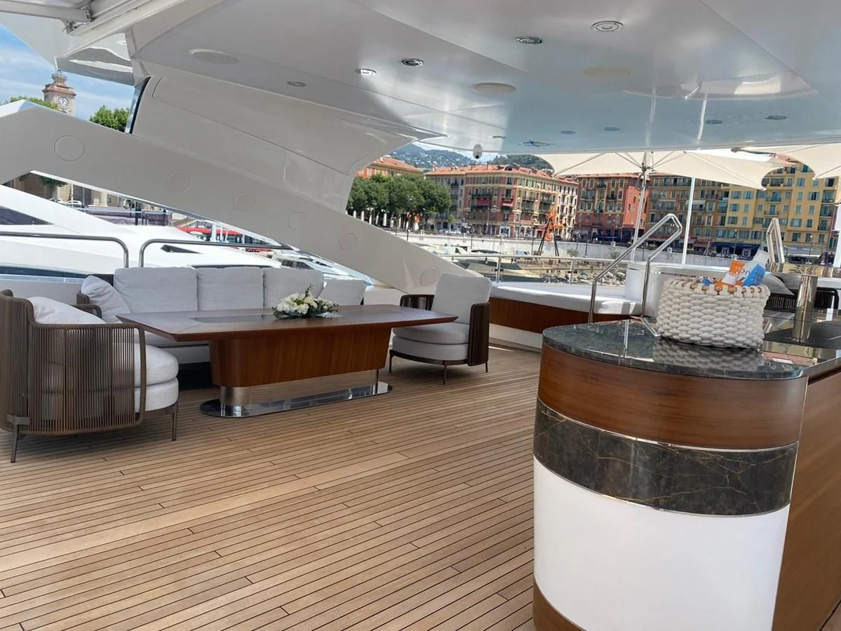 a glass of beer on a table in a restaurant aboard ANYA Yacht for Sale