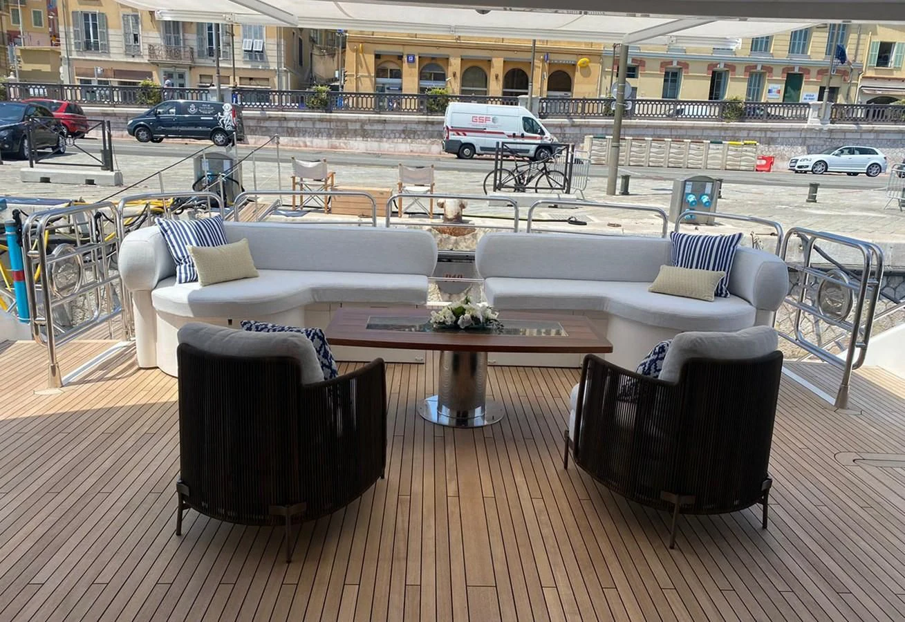 a table and chairs on a patio aboard ANYA Yacht for Sale