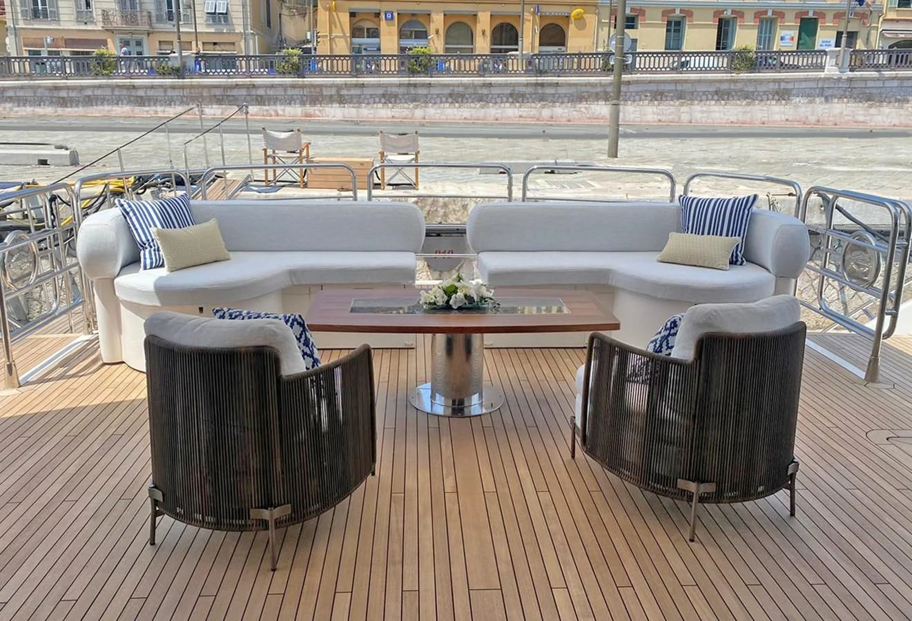a table and chairs on a deck aboard ANYA Yacht for Sale