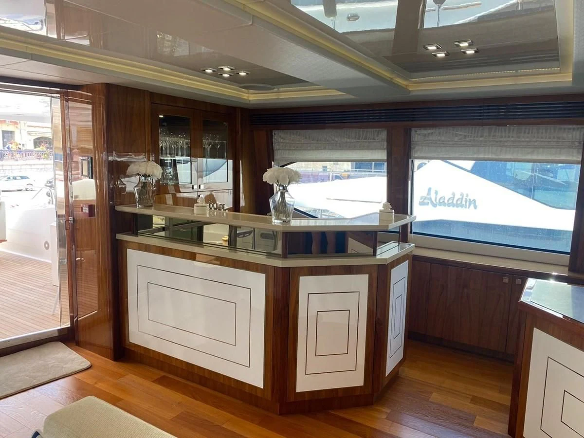 a room with a large window and a desk with a chair and a window with blinds and wood aboard ANYA Yacht for Sale