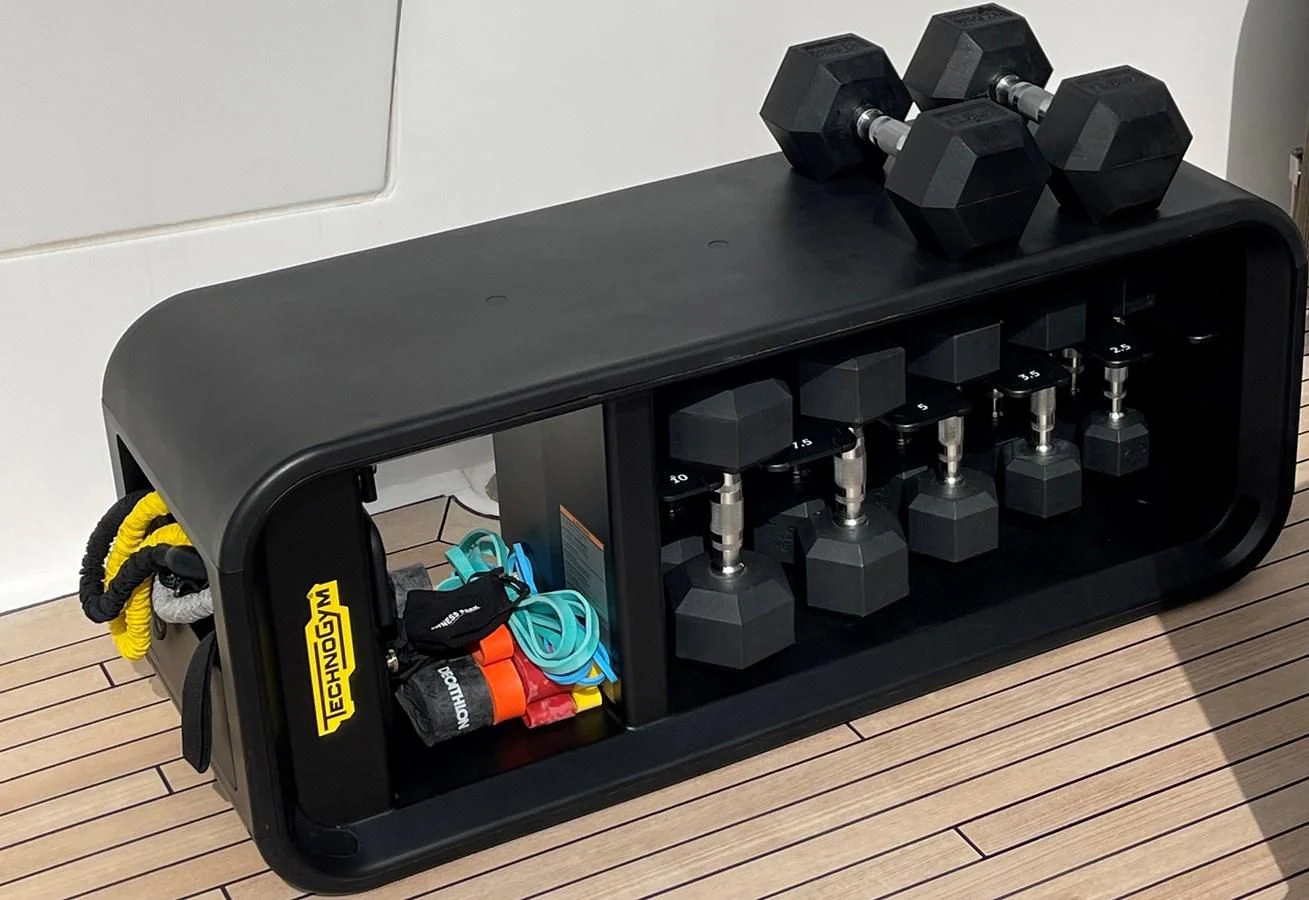 a black rectangular object with a black surface and a yellow and blue object on top aboard ANYA Yacht for Sale